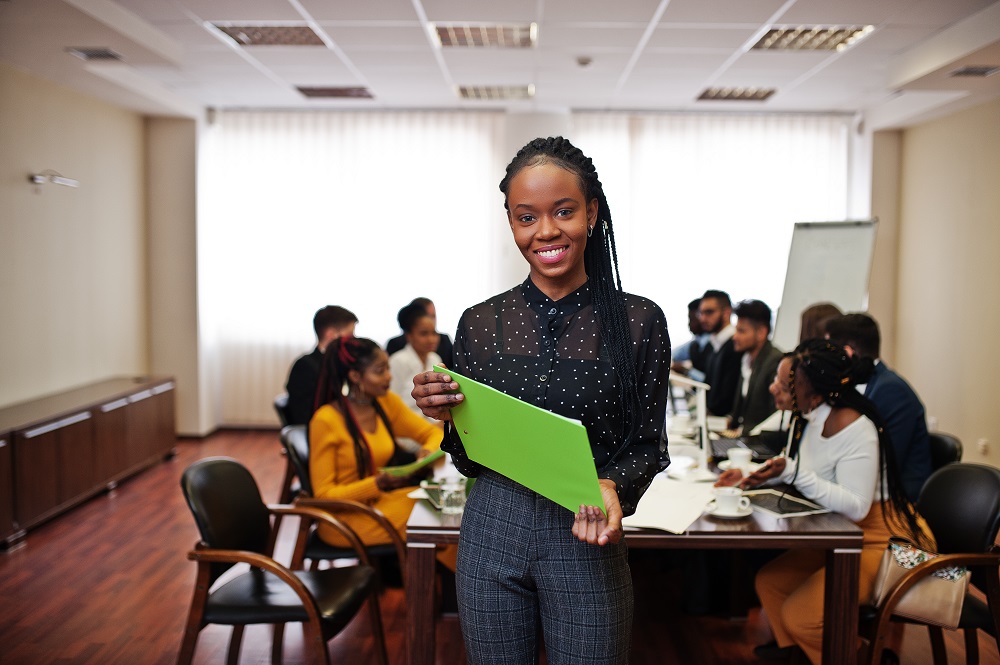 Face of handsome african business woman, holding clipboard on th